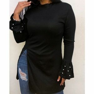 Cute black top with pearl detail on wrists!